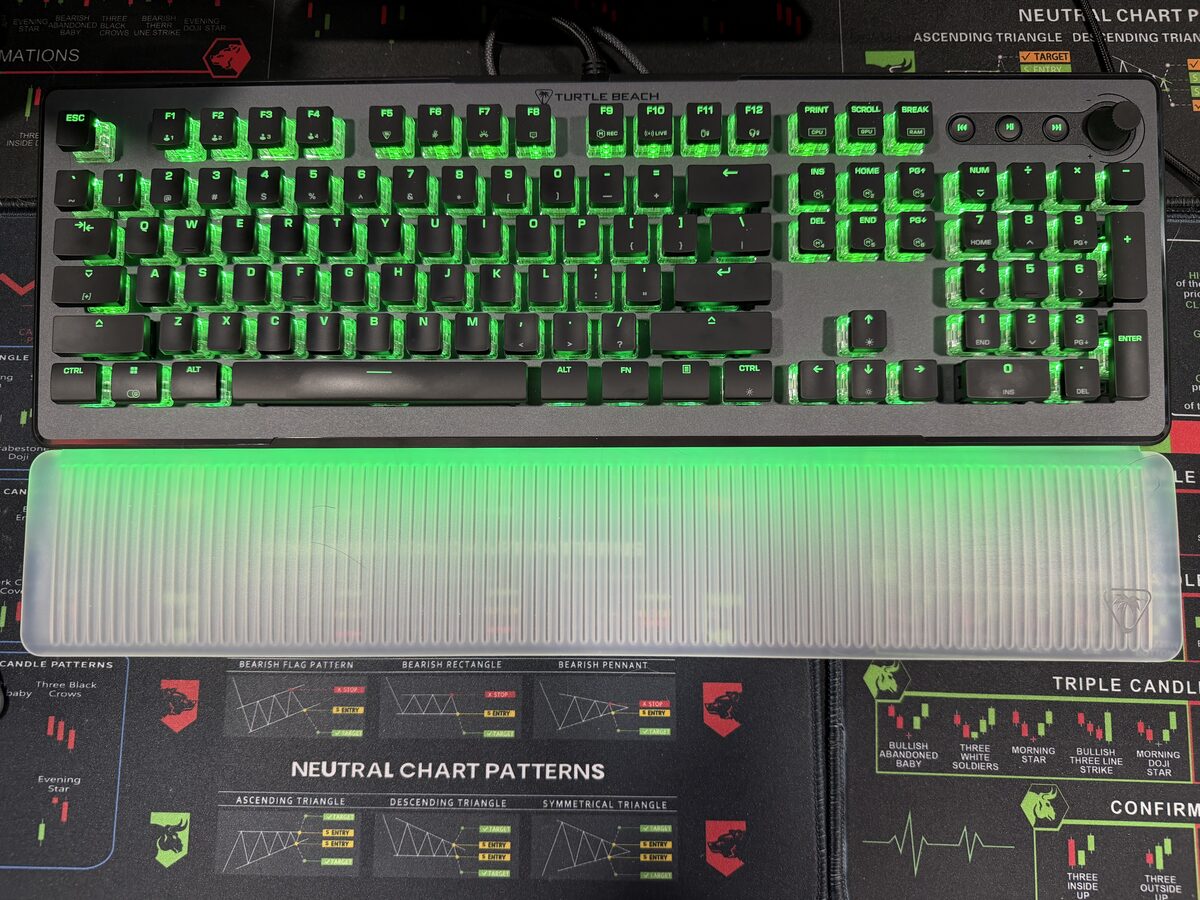 Turtle Beach Vulcan II Max mechanical keyboard with green RGB backlighting on trading desk mat